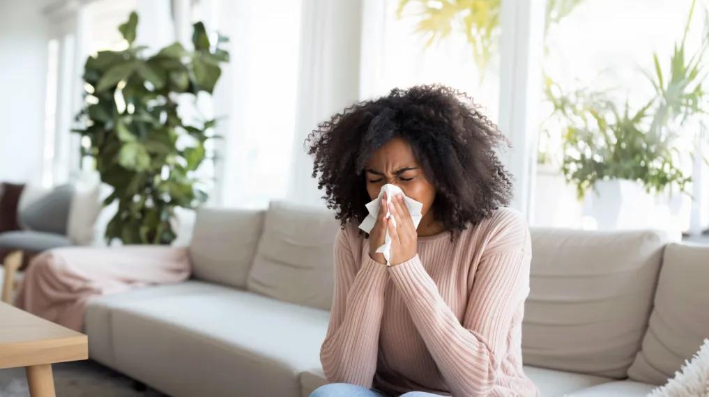 Woman blowing nose